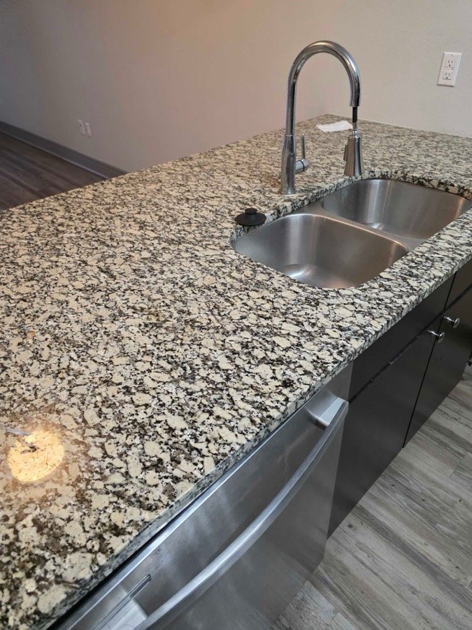 Granite kitchen sink after house cleaning in Overland Park, KS